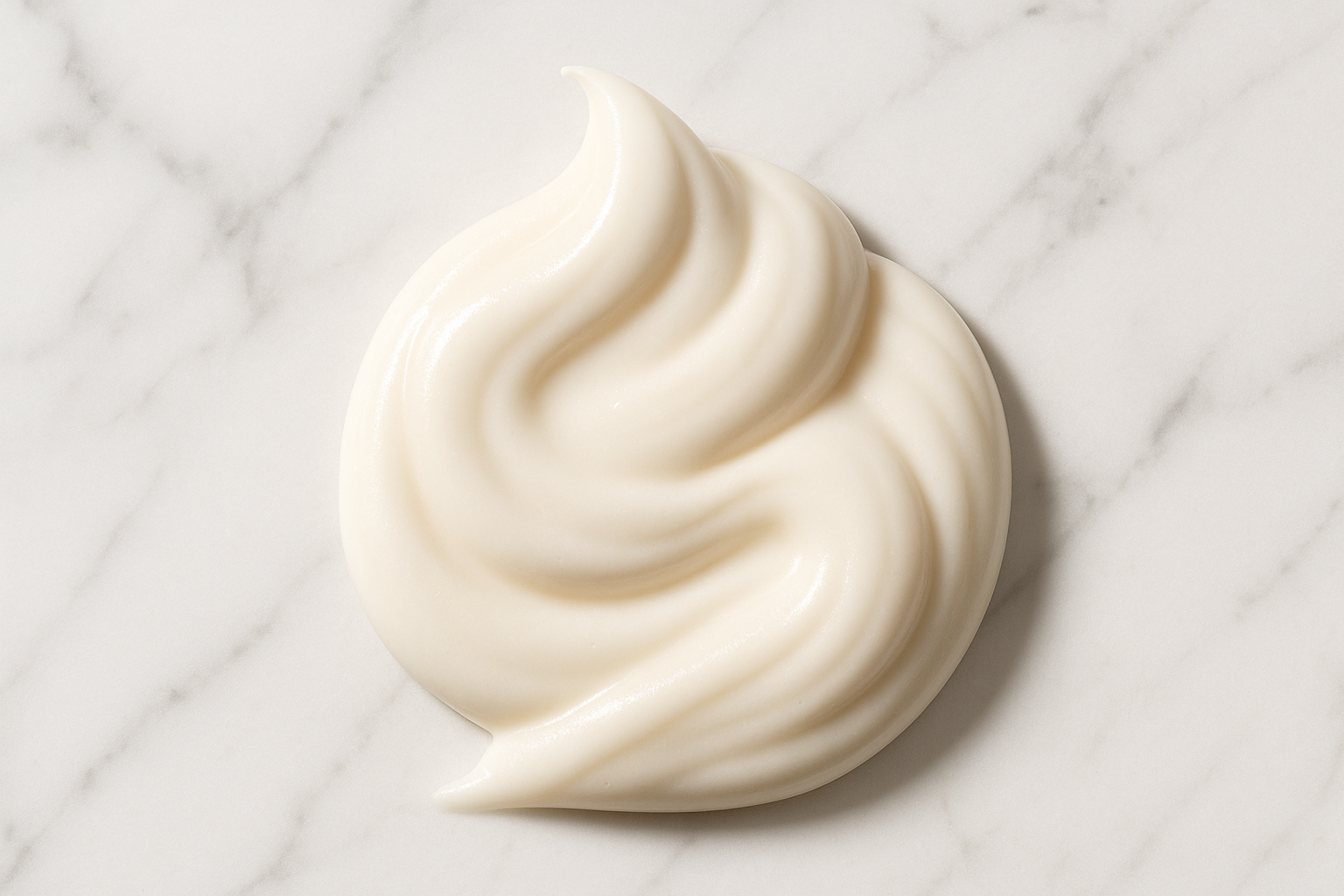 show beautiful luxurious milky cream mousse like conditioner on a white marble background